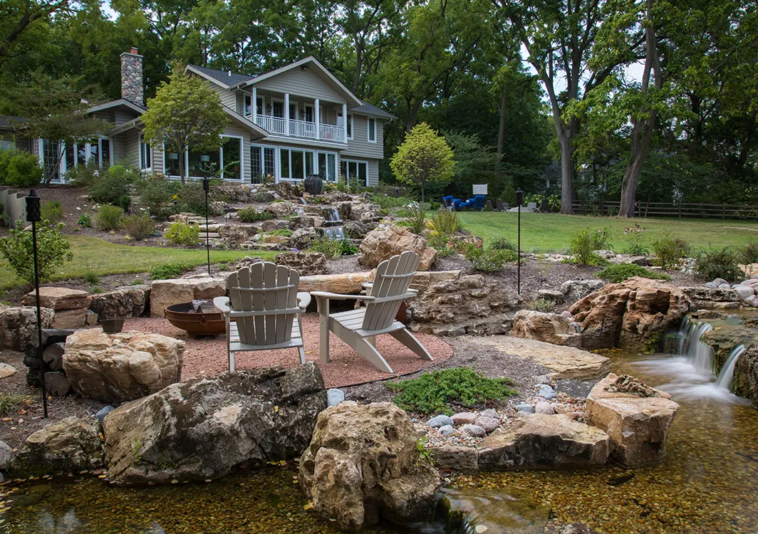 Serene garden with chairs and waterfall view