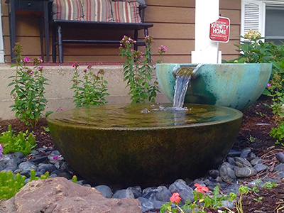 Garden water feature with flowing fountain bowls.