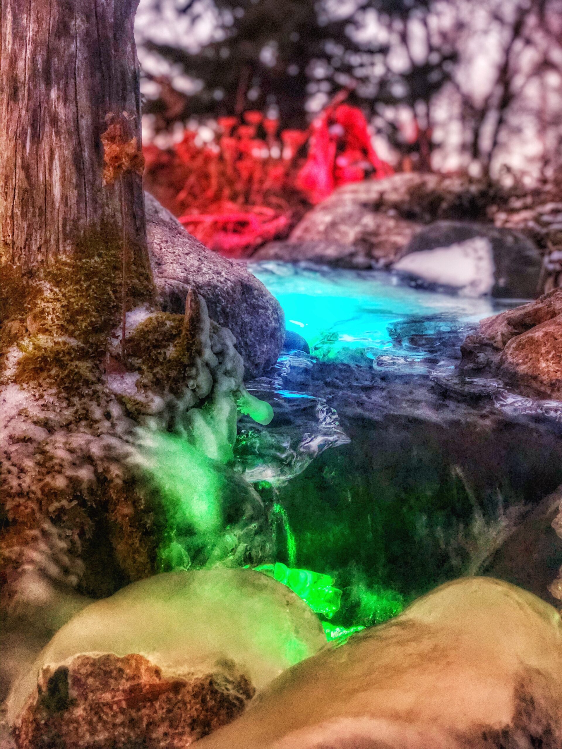 Colorful illuminated rocks and water in nature scene.